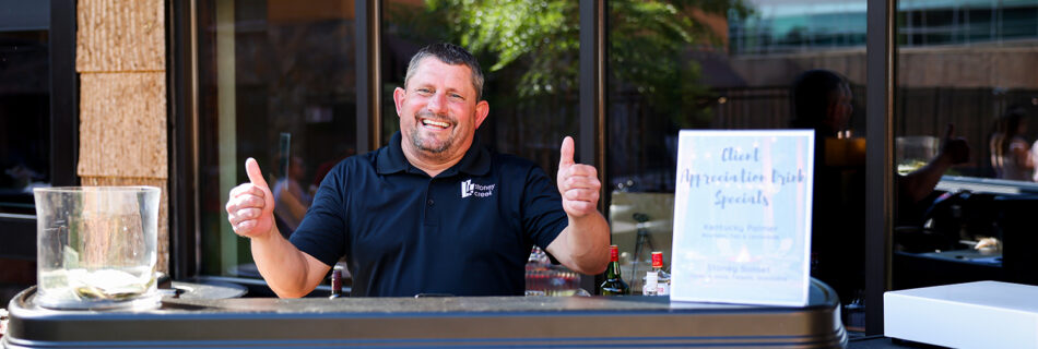 hotel event bartender giving two thumbs up