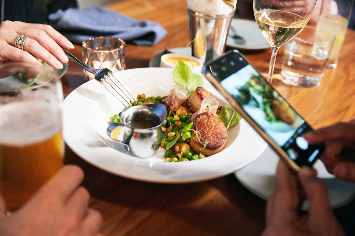 person taking photo of beautiful bowl of food with cell phone
