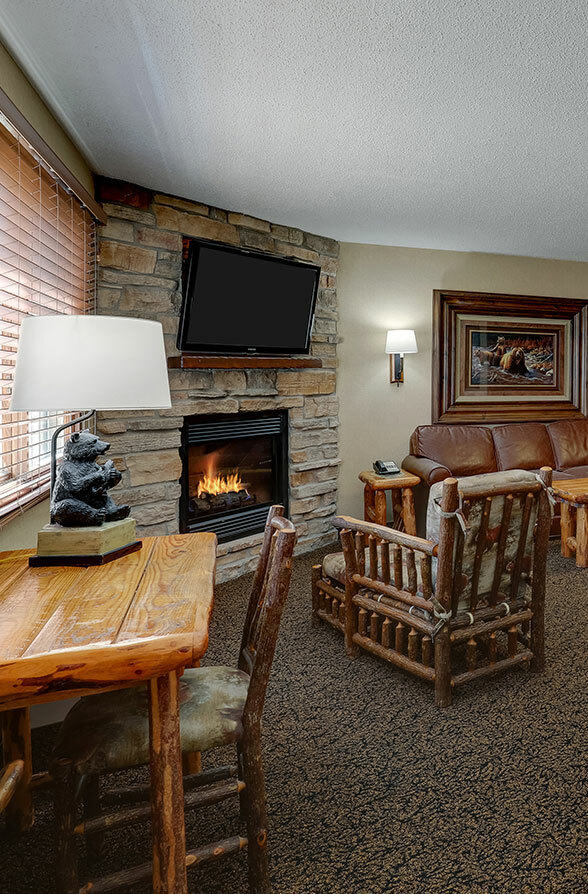 Stone fireplace with armchairs in hotel, Stoney Creek Inn Galena IL